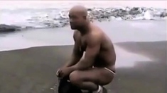 Asian bodybuilder barely covered at the beach