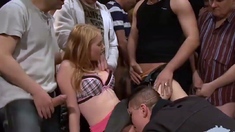 Petite blonde making the most of a gangbang